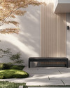 A serene Japandi front yard with a cohesive color palette, featuring a light grey exterior wall, natural blonde wood slatted screen, a minimalist dark grey bench, and subtle green Japanese maples and moss accents. — styling and décor detail