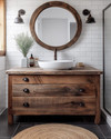 A cozy rustic bathroom featuring a reclaimed wood vanity with a white ceramic vessel sink, dark bronze faucet, and a large round mirror with a distressed wooden frame. White subway tile lines the lower wall, and a woven jute rug adds warmth to the dark grey floor tiles. — close-up of textures and materials
