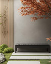 A serene Japandi front yard with a cohesive color palette, featuring a light grey exterior wall, natural blonde wood slatted screen, a minimalist dark grey bench, and subtle green Japanese maples and moss accents. — alternate angle