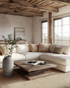 A cozy farmhouse poolhouse interior featuring a large cream sectional sofa with woven throw pillows, a distressed wood coffee table, and an exposed reclaimed wood ceiling. Soft light filters in, highlighting a natural fiber rug and a simple ceramic vase with greenery. — alternate angle