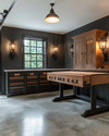 A traditional garage interior featuring a solid oak workbench, dark walnut storage cabinets with oil-rubbed bronze hardware, concrete flooring mimicking natural stone, and black iron industrial sconces. — styling and décor detail
