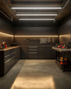 A modern minimalist garage featuring matte charcoal gray flat-panel cabinets, polished concrete flooring, integrated LED strip lighting, and a stainless steel workbench with organized tools on a dark slat wall. — styling and décor detail