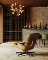 Mid-Century Modern wine cellar featuring a walnut Eames Lounge Chair, a Sputnik chandelier, sleek teak wine racks, and a concrete tasting bar with green upholstered stools. — close-up of textures and materials