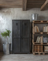 Industrial baby and kids room with a dark gray metal locker, a reclaimed wood pallet bookshelf, and a galvanized metal storage bucket on a concrete-effect accent wall. — close-up of textures and materials