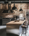 An industrial kitchen featuring exposed brick walls, a large stainless steel island with a butcher block top, and matte black factory-style pendant lights, complemented by distressed leather bar stools and a vintage metal sign. — styling and décor detail