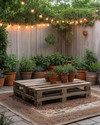 A budget-friendly Boho Backyard featuring a low wooden pallet coffee table, layered vintage rugs in muted terracotta and beige, and an assortment of potted green plants in upcycled terra cotta and ceramic containers, all illuminated by warm solar string lights strung overhead. — alternate angle