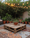 A budget-friendly Boho Backyard featuring a low wooden pallet coffee table, layered vintage rugs in muted terracotta and beige, and an assortment of potted green plants in upcycled terra cotta and ceramic containers, all illuminated by warm solar string lights strung overhead.