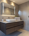 Modern bathroom with a floating dark wood vanity, white vessel sink, and large format grey wall tiles. Integrated LED mirror lighting and recessed ceiling lights illuminate the space, complemented by polished chrome fixtures. — close-up of textures and materials