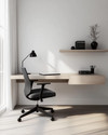 Modern home office with a minimalist aesthetic featuring a light oak floating desk, a black ergonomic chair, white walls, and a sleek matte black desk lamp. — styling and décor detail