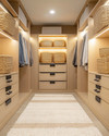A modern walk-in closet with light oak cabinetry, integrated warm LED lighting, and a cream plush rug. Woven rattan baskets and matte black hardware add a cozy, inviting feel to the organized space. — alternate angle