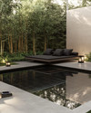 A serene Japandi pool area featuring a dark-tiled swimming pool surrounded by smooth concrete pavers and a low-slung teak daybed with charcoal cushions. Subtle solar-powered lanterns glow amidst pet-friendly green groundcover and slender bamboo plants. — alternate angle