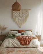 Boho bedroom with a low-slung bed, warm woven rattan pendant light, macrame wall hanging above the bed, and layered textiles in cream, terracotta, and soft green accents. — alternate angle