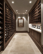 A refined traditional wine cellar featuring dark walnut wine racks, honed travertine flooring, smooth light grey plastered walls, and subtle recessed LED lighting, creating a clean and sophisticated ambiance. — close-up of textures and materials