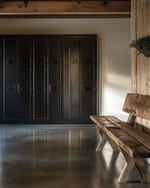 Minimalist industrial mudroom with matte black steel lockers, a polished concrete floor, and a reclaimed oak bench, illuminated by natural light. — alternate angle