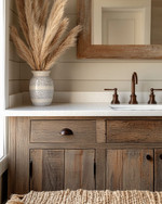 A cozy rustic powder room featuring a reclaimed wood vanity with an off-white quartz countertop, an oil-rubbed bronze faucet, and shiplap walls painted in a soft greige. A woven jute rug sits on the floor, and a ceramic vase with dried pampas grass adorns the counter. — close-up of textures and materials