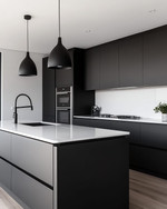 A sleek modern kitchen featuring matte black handleless cabinetry, white quartz countertops, integrated stainless steel appliances, and a minimalist black pendant light over a large kitchen island. — styling and décor detail