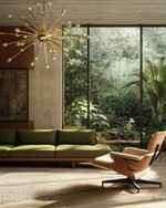 A Mid-Century Modern living room showcasing a low-slung olive green sofa with a walnut frame, an Eames Lounge Chair, and a brass Sputnik chandelier, all overlooking a lush garden through large windows. — alternate angle