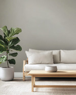 A minimalist Scandinavian Landscape living room with pale gray walls, an off-white modular sofa, a light ash wood coffee table, and a large Fiddle Leaf Fig plant in a matte ceramic pot. — alternate angle