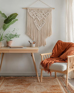 A cozy boho home office with a light wood desk, a macramé wall hanging, and a comfortable armchair, featuring a jute rug and a vibrant terracotta throw, designed for family and pet-friendly living.