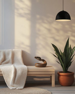 A Scandinavian porch featuring a light ash slatted bench with a cream knit throw, a small round teak coffee table, and a sculptural snake plant in a terracotta pot, all under the soft glow of a matte black outdoor pendant light. — close-up of textures and materials