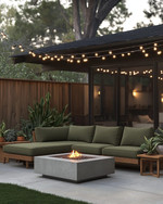 A cozy Mid-Century Modern backyard featuring a low-profile sectional with olive green cushions, a sleek concrete fire pit, and warm string lights draped overhead, complemented by teak side tables and potted snake plants. — alternate angle