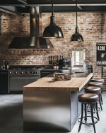 An industrial kitchen featuring exposed brick walls, a large stainless steel island with a butcher block top, and matte black factory-style pendant lights, complemented by distressed leather bar stools and a vintage metal sign. — styling and décor detail