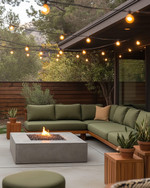 A cozy Mid-Century Modern backyard featuring a low-profile sectional with olive green cushions, a sleek concrete fire pit, and warm string lights draped overhead, complemented by teak side tables and potted snake plants.