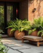 A serene Japandi-style driveway featuring large unglazed terracotta planters with lush green ferns, smooth concrete stepping stones, and subtle solar-powered pathway lights casting a warm glow. A simple wooden bench with a woven cushion sits near the entrance, embodying natural textures and minimalist design. — styling and décor detail