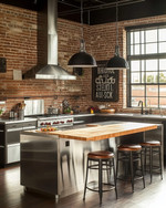 An industrial kitchen featuring exposed brick walls, a large stainless steel island with a butcher block top, and matte black factory-style pendant lights, complemented by distressed leather bar stools and a vintage metal sign. — alternate angle