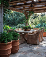 A rustic patio featuring a large flagstone patio surface, a solid wood dining table with woven rattan chairs, and terracotta planters filled with lush green plants under a natural wood pergola. — close-up of textures and materials