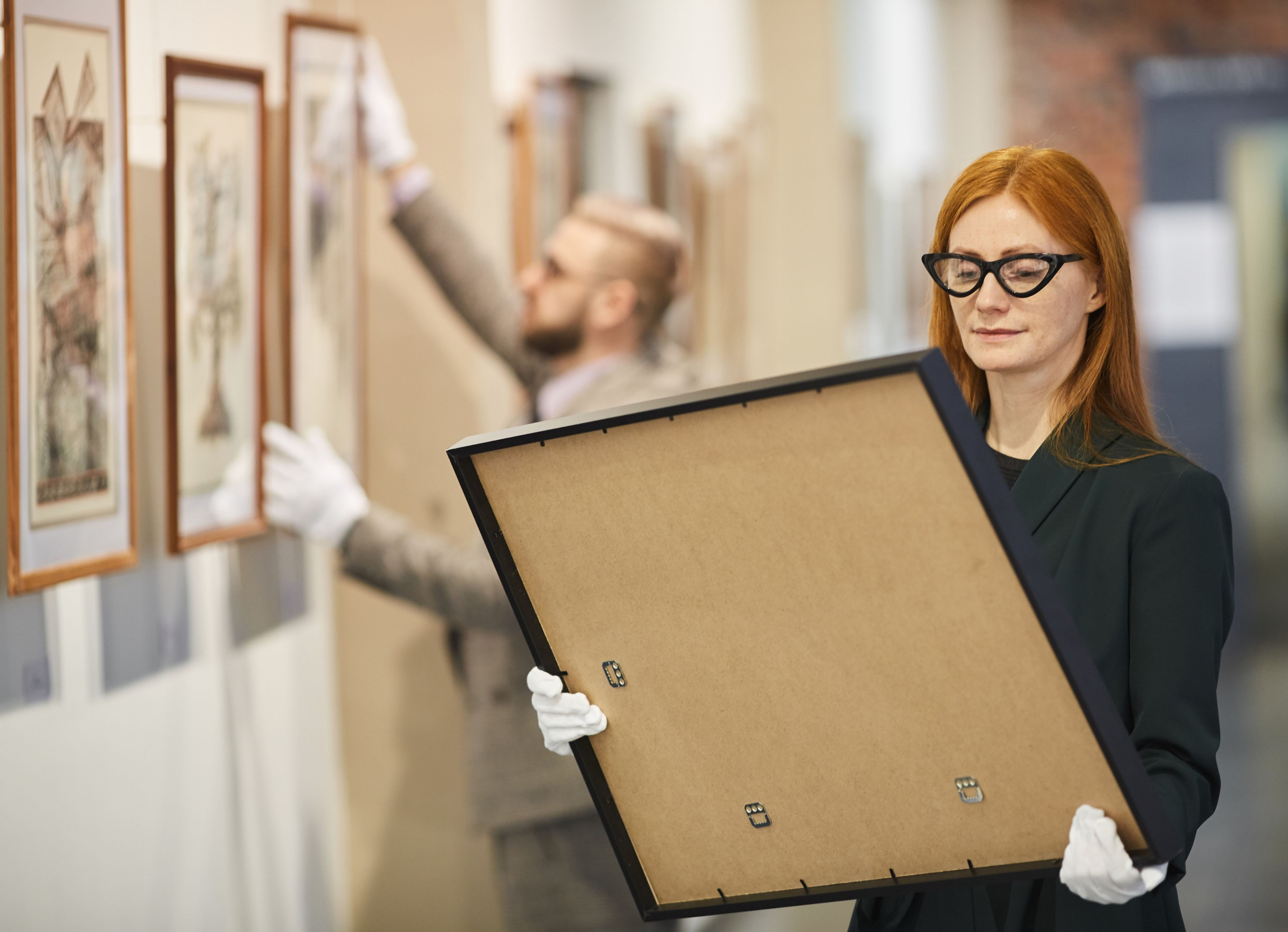 Catlin, founder of Family Wall Decor in her studio