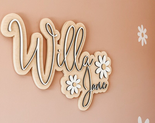 Daisy floral wood sign personalized with baby girl name in pastel pink script, perfect for floral nursery wall decor. | Familywalldecor