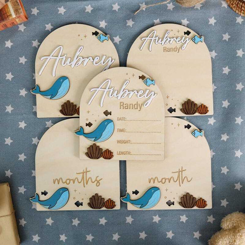 Nautical whale wood sign with monthly milestones for ocean-themed nursery, personalized baby name, navy blue wall decor | Family Wall Decor