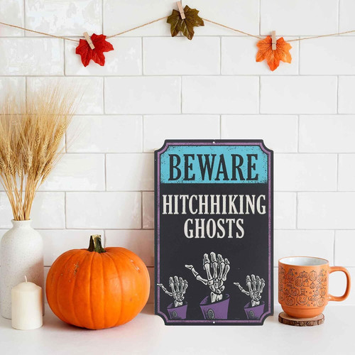 Haunted mansion Halloween metal sign with Beware of Hitchhiking Ghosts text for spooky wall decor in an entryway or hallway | Familywalldecor