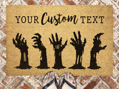 Halloween zombie doormat featuring undead hands and blood splatters, personalized with your family name for front porch decor | Familywalldecor