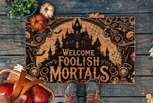 Welcome Foolish Mortals doormat for haunted house entryway, coir fiber with black gothic lettering, orange accents, outdoor | Familywalldecor