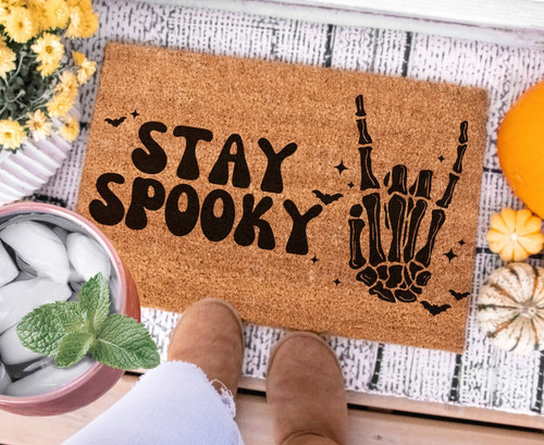 Cute skeleton Halloween doormat for entryway, featuring peace sign graphic; welcome mat for spooky season front porch decor | Familywalldecor