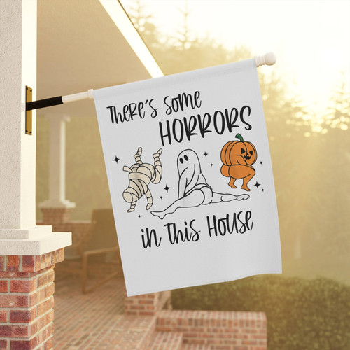 Halloween garden flag with 'There’s Some Horrors in This House' phrase, funny outdoor banner for spooky yard or porch decor | Familywalldecor
