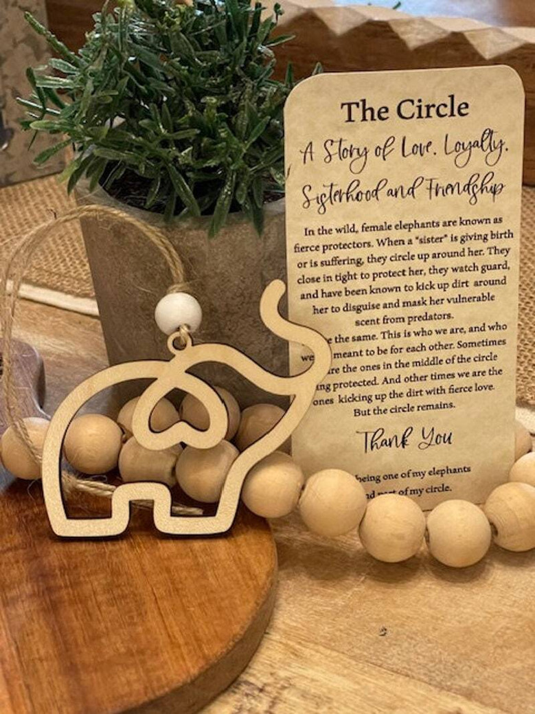 Elephant family ornament, simple maple wood design symbolizing sisterhood and friendship, with card and storage pouch.