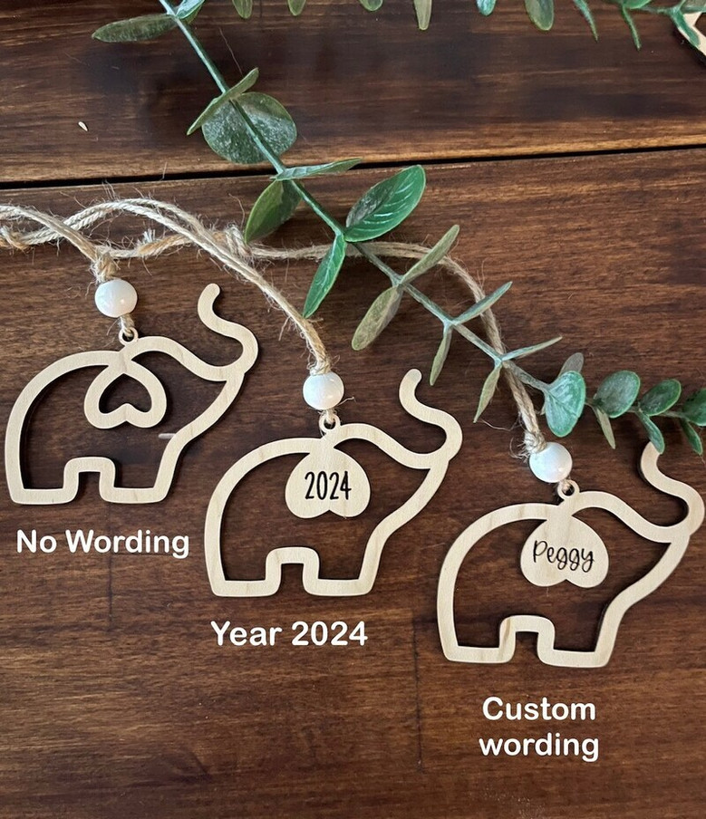 Elephant family ornament crafted in natural maple wood, a friendship keepsake with card and pouch for thoughtful gifting.