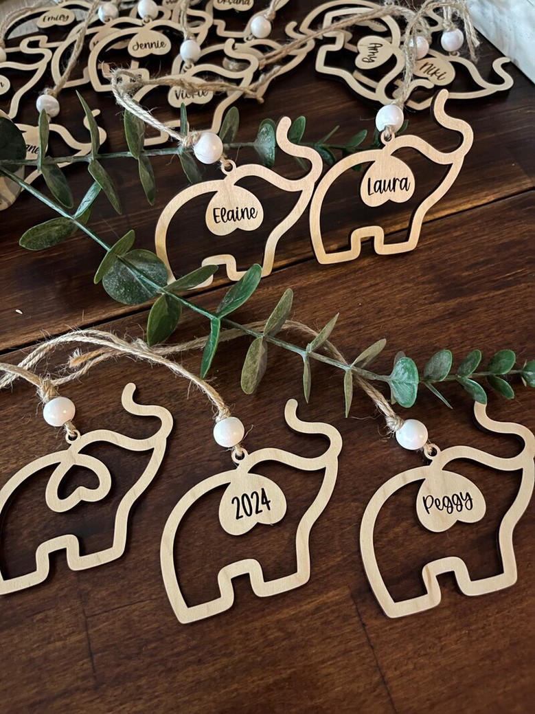 Elephant family ornament in maple wood honoring sisterhood and friendship, packaged with a sentiment card and fabric pouch.