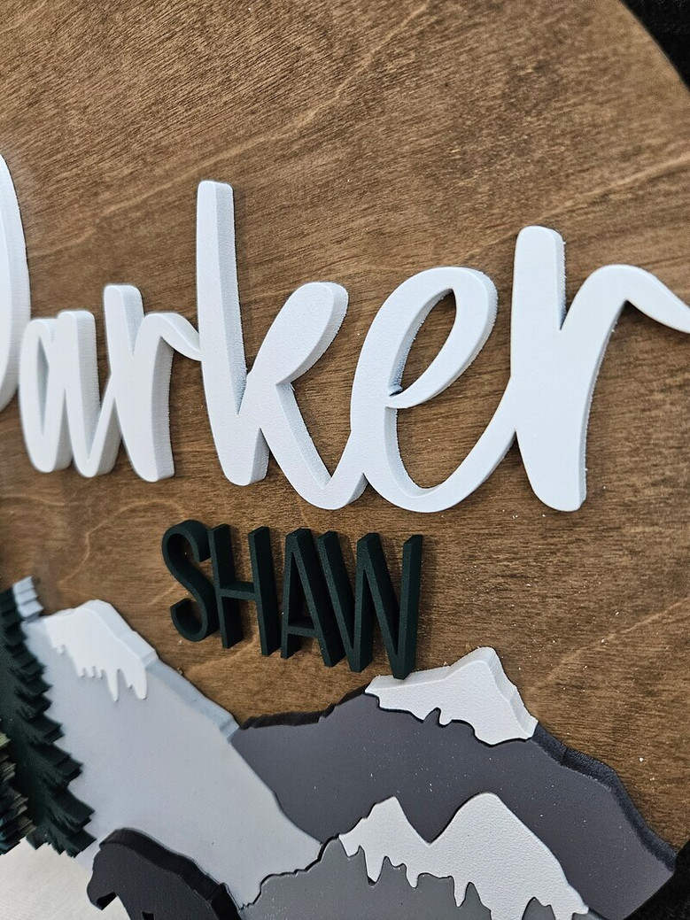 Woodland theme round wood nursery sign with personalized name in script, engraved pines; nursery wall decor for boys.