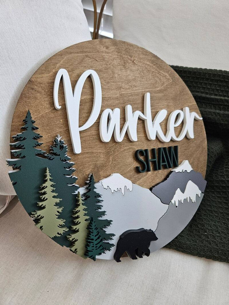 Woodland theme round wood nursery sign with custom name, fox and bear motifs, dark walnut finish; sweet baby shower gift.
