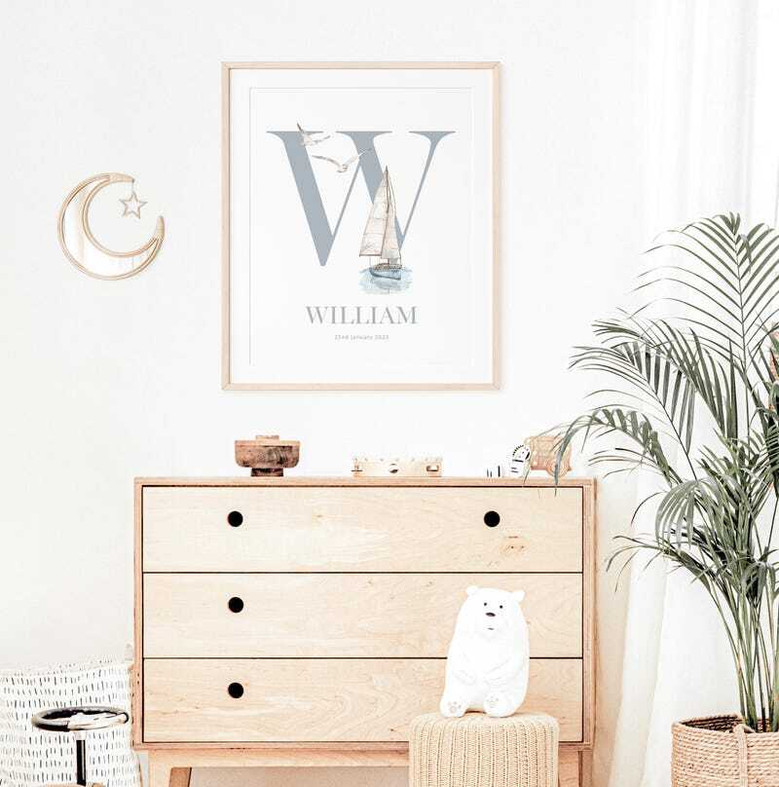 Nautical nursery canvas art print with a personalized sailboat motif and child’s name, wall decor for a baby boy bedroom