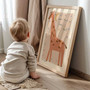 Giraffe canvas wall art for kids room in boho rainbow accents, beige background, portrait format for nursery gallery wall