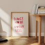 Dance More, Worry Less quote canvas for girls' room, black typography on white, thin black frame, clean modern decor accent